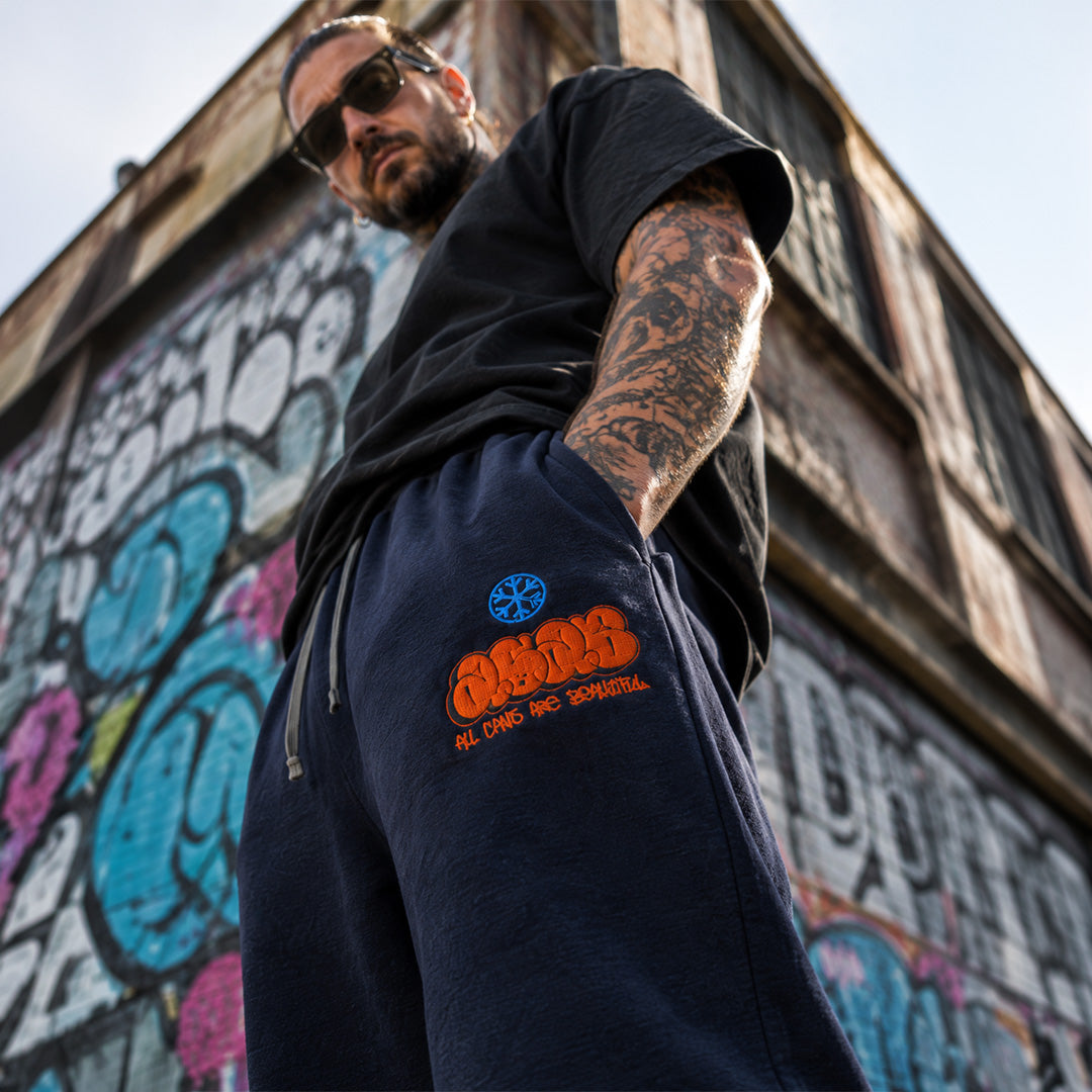 Navy-ACAB Graffiti Throw-up Joggers from B.Different Clothing, close-up male model, graffiti-inspired streetwear
