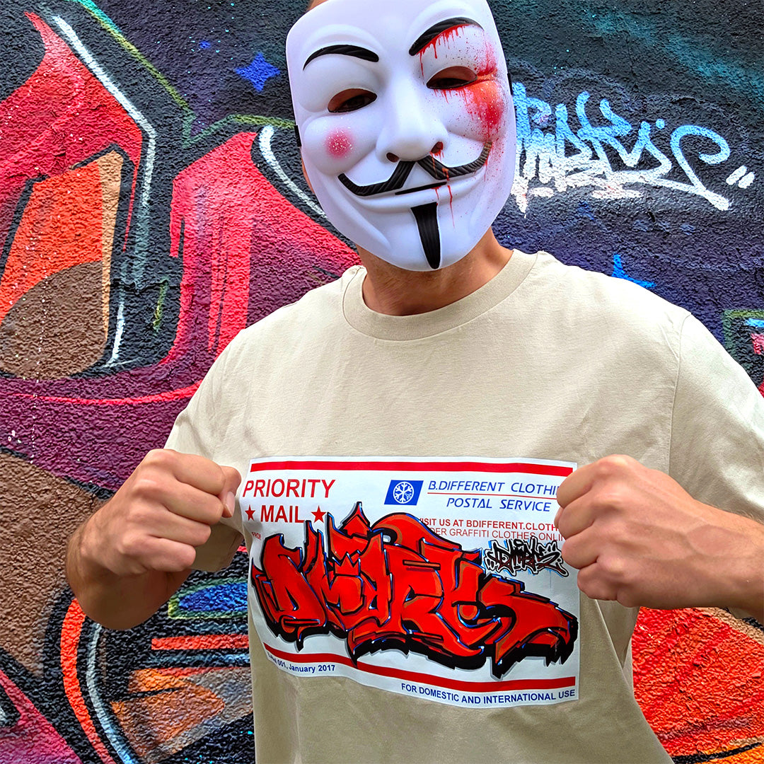 Beige-Dmark wearing Priority Mail Sticker Graffiti Tee from B.Different Clothing, graffiti-inspired streetwear t-shirt