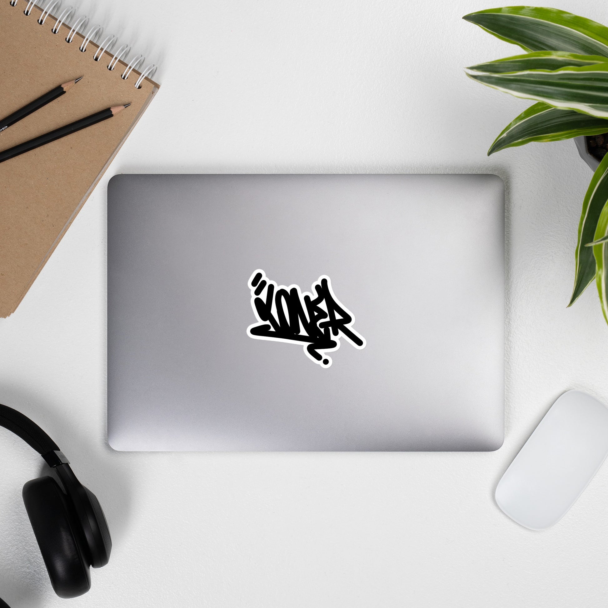 laptop with Loner Tag sticker by B.Different Clothing street art graffiti inspired streetwear brand