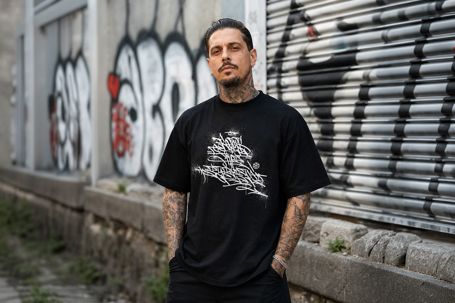 Man wearing Bomb The System Graffiti Tee by Shew from B.Different Clothing, graffiti-inspired streetwear